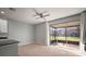 The dining area features sliding glass doors that lead to a screened patio with views of the backyard at 7047 Towne Lake Rd, Riverview, FL 33578
