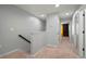 Upstairs hallway with plush carpet, neutral paint and two doors at 7047 Towne Lake Rd, Riverview, FL 33578
