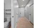 Well-lit hallway leading to the front door and a nearby half bathroom at 7047 Towne Lake Rd, Riverview, FL 33578