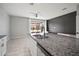 Bright kitchen with a large island, granite countertops, and stainless steel sink overlooking the backyard at 7047 Towne Lake Rd, Riverview, FL 33578