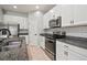 Stainless steel oven and range, as well as granite countertops, compliment this modern kitchen at 7047 Towne Lake Rd, Riverview, FL 33578