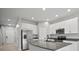Updated kitchen with granite countertops, stainless steel appliances, and white cabinetry at 7047 Towne Lake Rd, Riverview, FL 33578