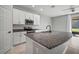 Modern kitchen features stainless appliances, granite countertops and white cabinetry at 7047 Towne Lake Rd, Riverview, FL 33578