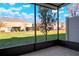 Screened lanai overlooking the lawn and a small tree in the yard at 7047 Towne Lake Rd, Riverview, FL 33578