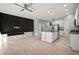 Spacious open-concept living space with kitchen, black accent wall, and custom built-ins at 7047 Towne Lake Rd, Riverview, FL 33578