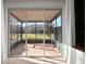 Screened-in patio provides a seamless transition to the outdoors and views of the landscaped backyard at 7047 Towne Lake Rd, Riverview, FL 33578
