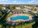 Aerial view of the community pool with chairs, tables, and a surrounding fence at 7047 Towne Lake Rd, Riverview, FL 33578