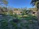 Spacious backyard featuring green grass, a swing set, and covered patio at 7126 Oelsner St, New Port Richey, FL 34652