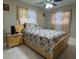Well-lit bedroom featuring a ceiling fan, large window, and light-colored walls at 7126 Oelsner St, New Port Richey, FL 34652