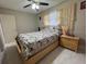 Bright bedroom with natural light, a ceiling fan, and a side table at 7126 Oelsner St, New Port Richey, FL 34652