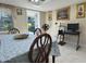 Bright dining area with view to the yard, a traditional table, and attractive wainscoting at 7126 Oelsner St, New Port Richey, FL 34652
