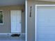 Front entrance and garage door with house number for easy identification and visitor access at 7126 Oelsner St, New Port Richey, FL 34652