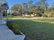 Landscaped front yard of home with green grass and healthy shrubbery for a cared for feel at 7126 Oelsner St, New Port Richey, FL 34652