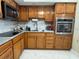 Traditional kitchen with wood cabinetry, stainless steel appliances, and ample counter space for meal preparation at 7126 Oelsner St, New Port Richey, FL 34652