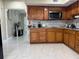 Traditional kitchen with wood cabinetry, stainless steel appliances, and ample counter space for meal preparation at 7126 Oelsner St, New Port Richey, FL 34652