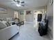 Bright living room with tile flooring, comfortable seating, and stylish decorative elements at 7126 Oelsner St, New Port Richey, FL 34652