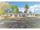 The backyard has a covered patio, a lush green lawn, and plants at 766 86Th N Ave, St Petersburg, FL 33702