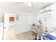 Bright bedroom featuring a bed with a blue blanket, a desk, and a view of the outdoors at 766 86Th N Ave, St Petersburg, FL 33702