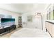 Bright bedroom featuring neutral tones, a modern media center, and natural light at 766 86Th N Ave, St Petersburg, FL 33702