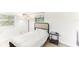 Bedroom with light wood floors, neutral walls, and a cozy bed with a black metal frame at 766 86Th N Ave, St Petersburg, FL 33702