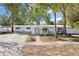 Charming single-story home with a covered entry, well-manicured lawn, and a boat on the driveway at 766 86Th N Ave, St Petersburg, FL 33702