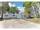 Inviting single-story home with mature trees and a spacious driveway at 766 86Th N Ave, St Petersburg, FL 33702