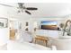 Bright living room featuring neutral furniture, ceiling fan, and large television with built-in shelving at 766 86Th N Ave, St Petersburg, FL 33702
