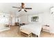 Bedroom with natural light, a ceiling fan, an accent bench, and an adjacent study area at 766 86Th N Ave, St Petersburg, FL 33702
