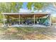 Backyard shed/garage with wood beams, holding workout machines, bicycles, and other equipment at 766 86Th N Ave, St Petersburg, FL 33702