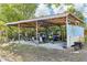 Backyard shed/garage with wood beams, holding workout machines, bicycles, and a painted mural at 766 86Th N Ave, St Petersburg, FL 33702