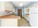 White cabinets and wood countertops can be found in this bright and airy kitchen space at 7811 Egypt Lake Dr, Tampa, FL 33614