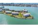 Stunning aerial view of waterfront condo complex surrounded by lush landscaping and picturesque water views at 8040 Sailboat Key S Blvd # 402, St Pete Beach, FL 33707