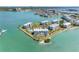 Breathtaking aerial view of waterfront condos, lush landscaping, and community pool at 8040 Sailboat Key S Blvd # 402, St Pete Beach, FL 33707