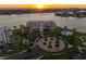 Sunset aerial view of the condo community with beautiful landscaping, pool, and community grounds at 8040 Sailboat Key S Blvd # 402, St Pete Beach, FL 33707