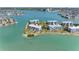 Scenic aerial view showcasing a waterfront condo complex with manicured grounds and serene water surroundings at 8040 Sailboat Key S Blvd # 402, St Pete Beach, FL 33707