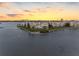 Aerial view of the condo community on the water's edge, showcasing lush lawns and mature trees at 8040 Sailboat Key S Blvd # 402, St Pete Beach, FL 33707