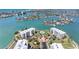 Stunning aerial view of the condominium complex showcases the lush landscaping and water views at 8040 Sailboat Key S Blvd # 402, St Pete Beach, FL 33707