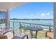 Relaxing balcony with comfortable seating and a picturesque view of the waterfront and coastline at 8040 Sailboat Key S Blvd # 402, St Pete Beach, FL 33707