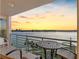 Balcony seating featuring a scenic view of the water and vibrant sunset at 8040 Sailboat Key S Blvd # 402, St Pete Beach, FL 33707