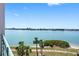 Beautiful balcony with view of serene water and lush palm trees at 8040 Sailboat Key S Blvd # 402, St Pete Beach, FL 33707