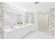 Beautiful bathroom features double sinks, shower, and soaking tub at 8040 Sailboat Key S Blvd # 402, St Pete Beach, FL 33707