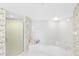 Bright bathroom featuring a large tub and glass shower, providing a luxurious retreat at 8040 Sailboat Key S Blvd # 402, St Pete Beach, FL 33707