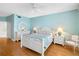 Bedroom with a ceiling fan, lamps, and a classic white bed frame and other white furniture at 8040 Sailboat Key S Blvd # 402, St Pete Beach, FL 33707