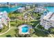 A beautiful condominium community with a sparkling pool, lush landscaping, and stunning waterfront views at 8040 Sailboat Key S Blvd # 402, St Pete Beach, FL 33707