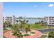 Scenic view of community with palm trees and buildings with a view of the water and skyline at 8040 Sailboat Key S Blvd # 402, St Pete Beach, FL 33707