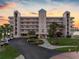 Elegant waterfront condominium building showcasing meticulous landscaping and parking at 8040 Sailboat Key S Blvd # 402, St Pete Beach, FL 33707