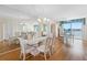 Bright dining room featuring a glass table, mirrored wall, and a view of the waterfront at 8040 Sailboat Key S Blvd # 402, St Pete Beach, FL 33707