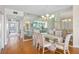 Spacious dining room with hardwood floors, mirrored wall, and chandelier lighting at 8040 Sailboat Key S Blvd # 402, St Pete Beach, FL 33707