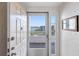 Bright entryway with a storm door showcasing water views and allowing natural light to fill the space at 8040 Sailboat Key S Blvd # 402, St Pete Beach, FL 33707