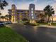 Stunning exterior of condo building featuring manicured landscaping and convenient parking, located near the waterfront at 8040 Sailboat Key S Blvd # 402, St Pete Beach, FL 33707